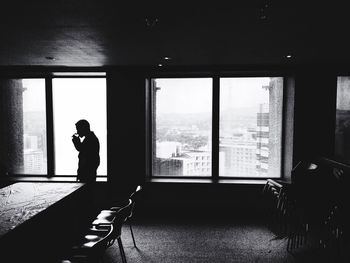 Man standing by window