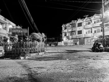 Street amidst buildings in city at night