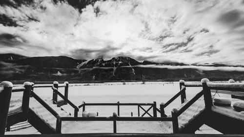 Scenic view of sea and mountains against sky