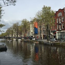 Boats in river with buildings in background