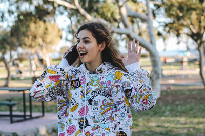 Portrait of smiling young woman standing outdoors