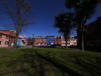 Houses and buildings against blue sky