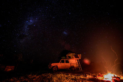 Built structure on field against sky at night