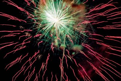 Low angle view of firework display at night