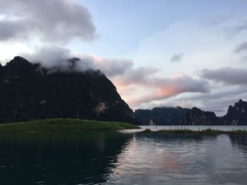 Scenic view of lake against cloudy sky