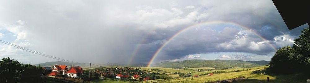 Rainbow over mountain against sky