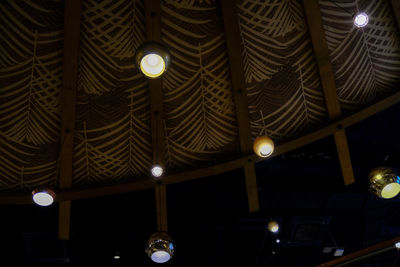 Low angle view of illuminated pendant light hanging from ceiling