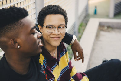 Portrait of smiling young man using smart phone