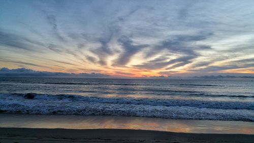 Scenic view of beach against sky during sunset