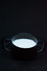 Close-up of coffee on table against black background