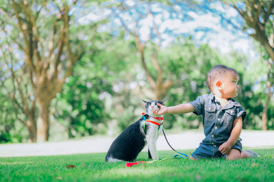 Rear view of man with dog against plants