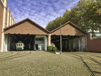 Houses by street against sky in city