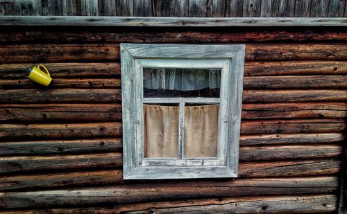 Close-up of window on wooden door