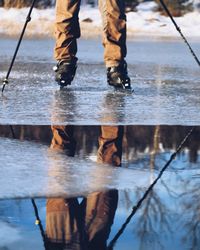 Low section of person on puddle during rainy season