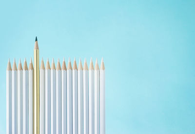 Close-up of colored pencils against blue background