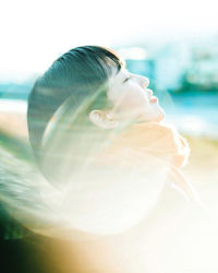 Close-up of boy against sea
