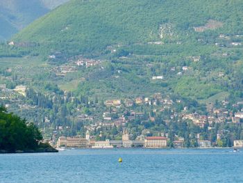 Scenic view of sea by buildings in city