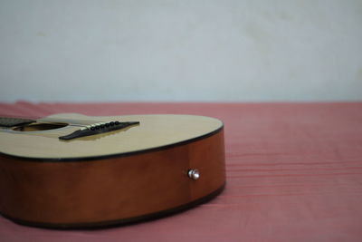 Close-up of guitar on table