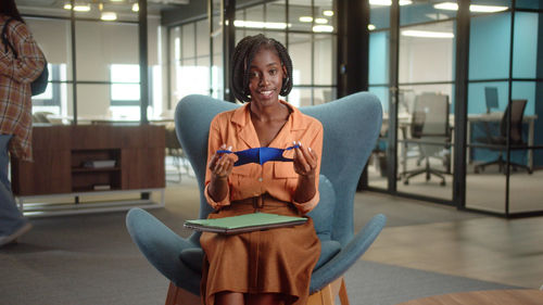 Portrait of businesswoman sitting on sofa