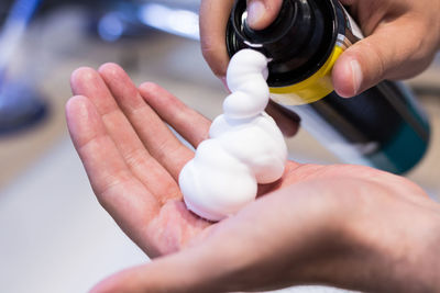 Cropped hand with shaving foam