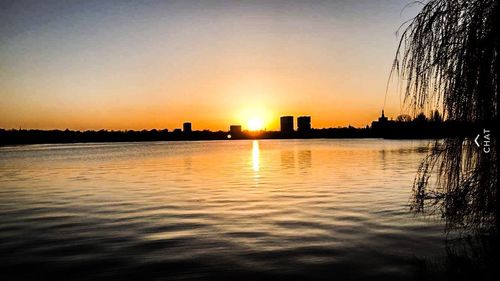 Scenic view of lake against sky during sunset