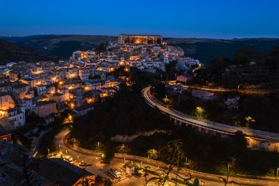 High angle view of city lit up at night