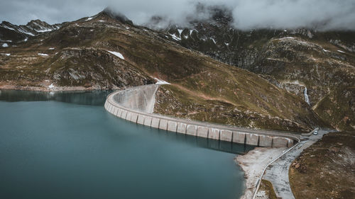 High angle view of river amidst mountains against sky