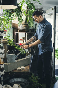 Mid adult man working in plant shop