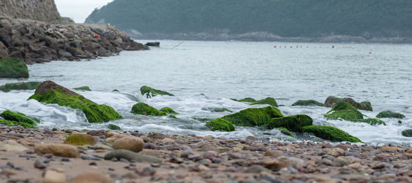 Scenic view of sea against rocky mountains