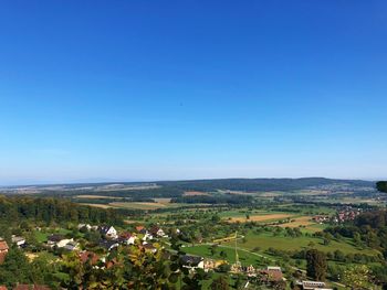 Scenic view of field against clear blue sky