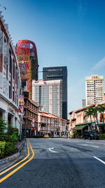 Buildings in city against clear sky