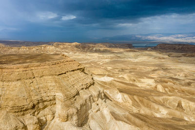 View of desert against cloudy sky