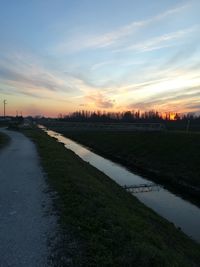 Scenic view of river against sky during sunset