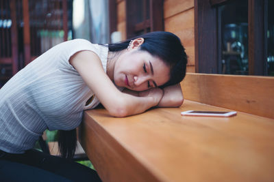 Portrait of young woman on table