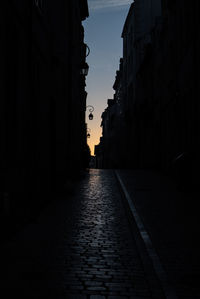 Surface level of road along buildings at sunset