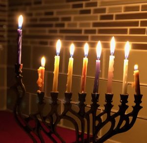 Close-up of illuminated candles on candlestick holder