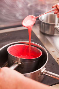 Midsection of person pouring tea cup