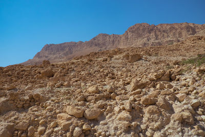 Scenic view of desert against clear blue sky