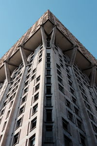 Low angle view of modern building against clear blue sky