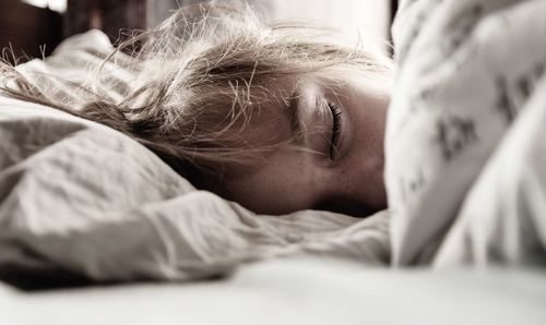 Close-up of boy sleeping on bed