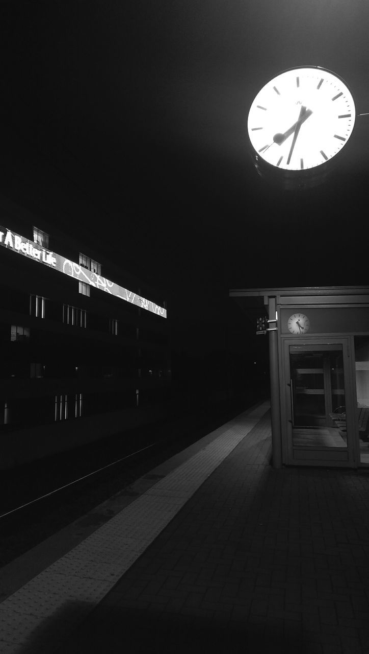 illuminated, architecture, built structure, night, lighting equipment, clock, indoors, ceiling, transportation, no people, time, building exterior, low angle view, railroad station, absence, entrance, empty, electric light, wall - building feature