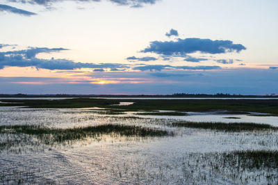 Scenic view of beach against sky during sunset