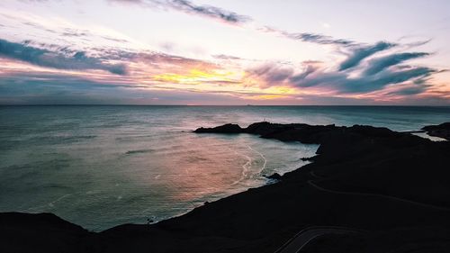 Scenic view of sea against cloudy sky