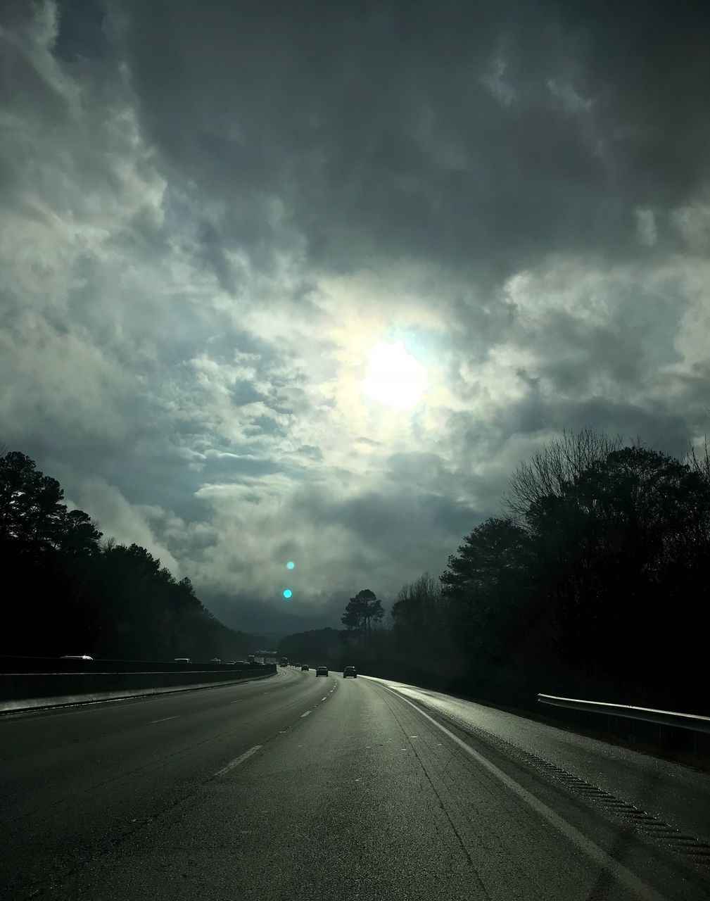 VIEW OF ROAD AGAINST CLOUDY SKY