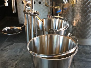 High angle view of drink running from faucet in buckets