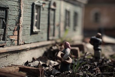 Figurines by old abandoned building