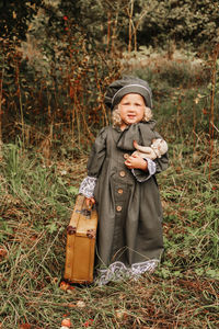 Portrait of boy standing on field