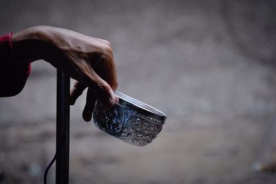 Close-up of senior woman hand holding bowl