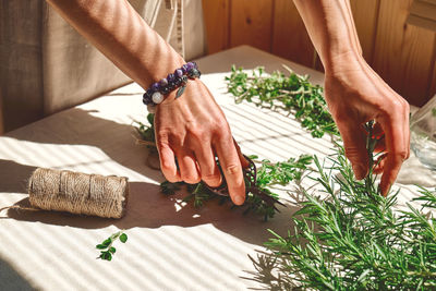 Alternative medicine. herbalist woman holding in her hands a bunch of scented rosemary. 