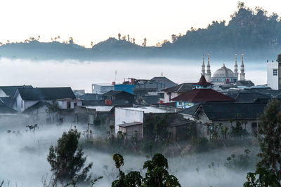 Fog enveloped residents in the dieng plateau, in central java.